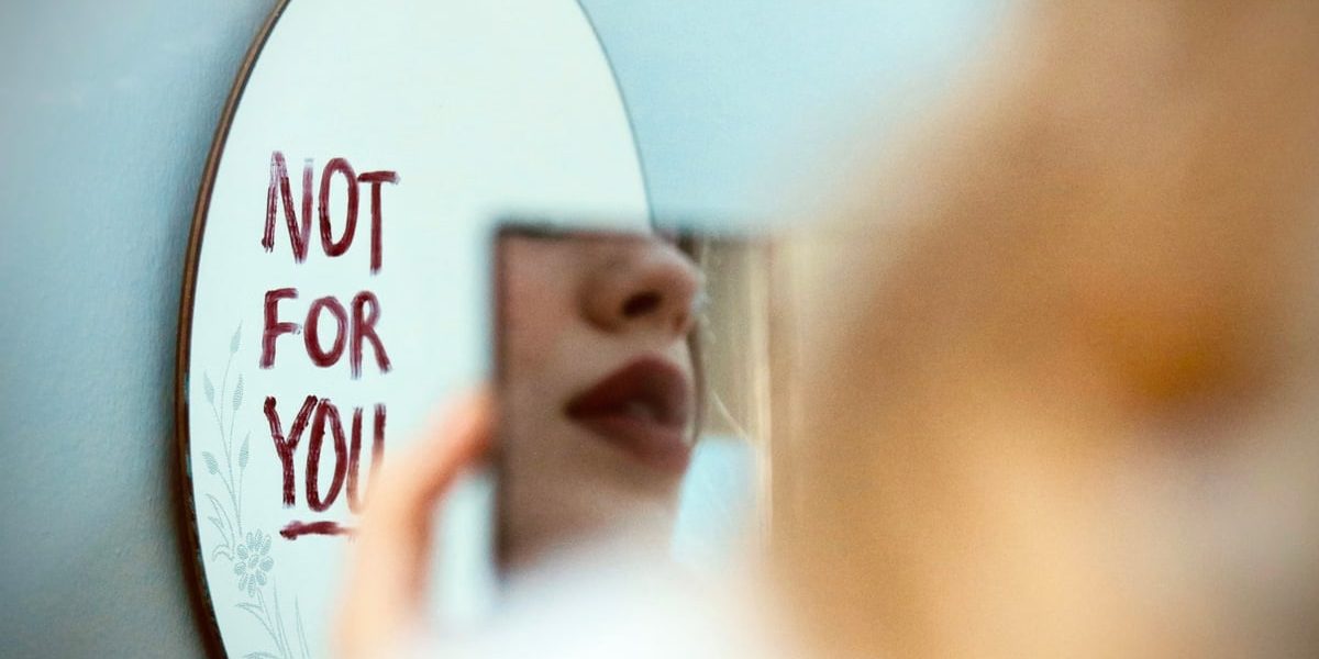 Artistic photo featuring a mirror reflection with 'Not for You' message, evoking mood and introspection.